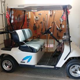 MaxSold Auction: This online auction feature EZGO Golf cart. Model year 2000.  Runs on gas. Has windshield, wood-grain dash, cloth seats, and has been well-maintained.  It just came back from a tune-up and is running.